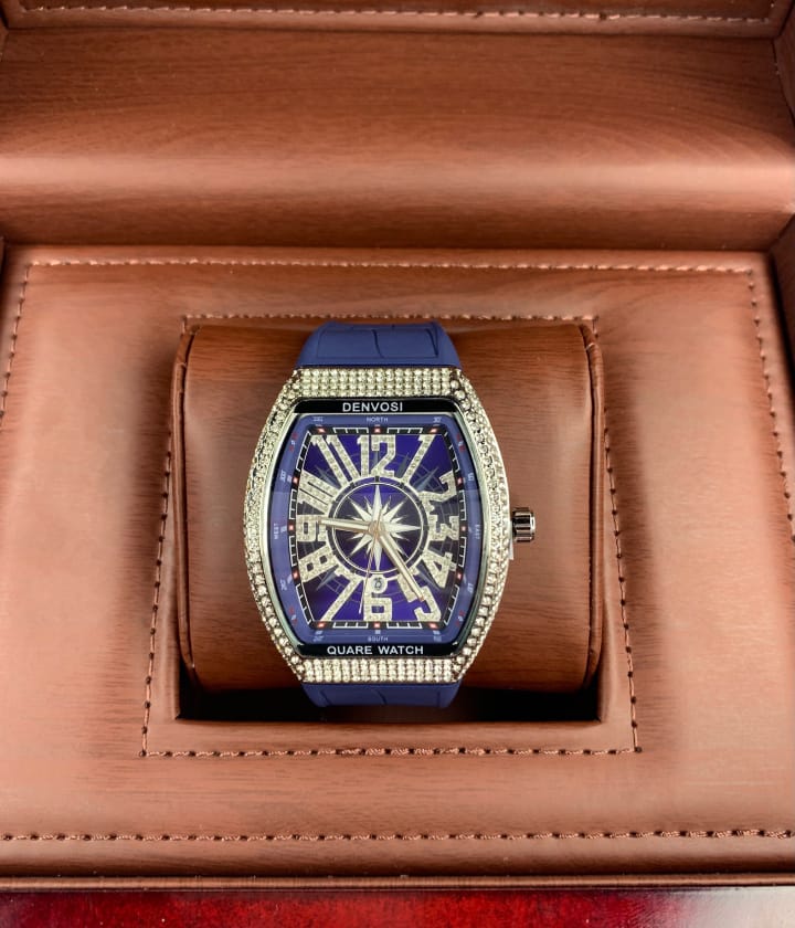 Blue watch with decorative face in a brown leather box